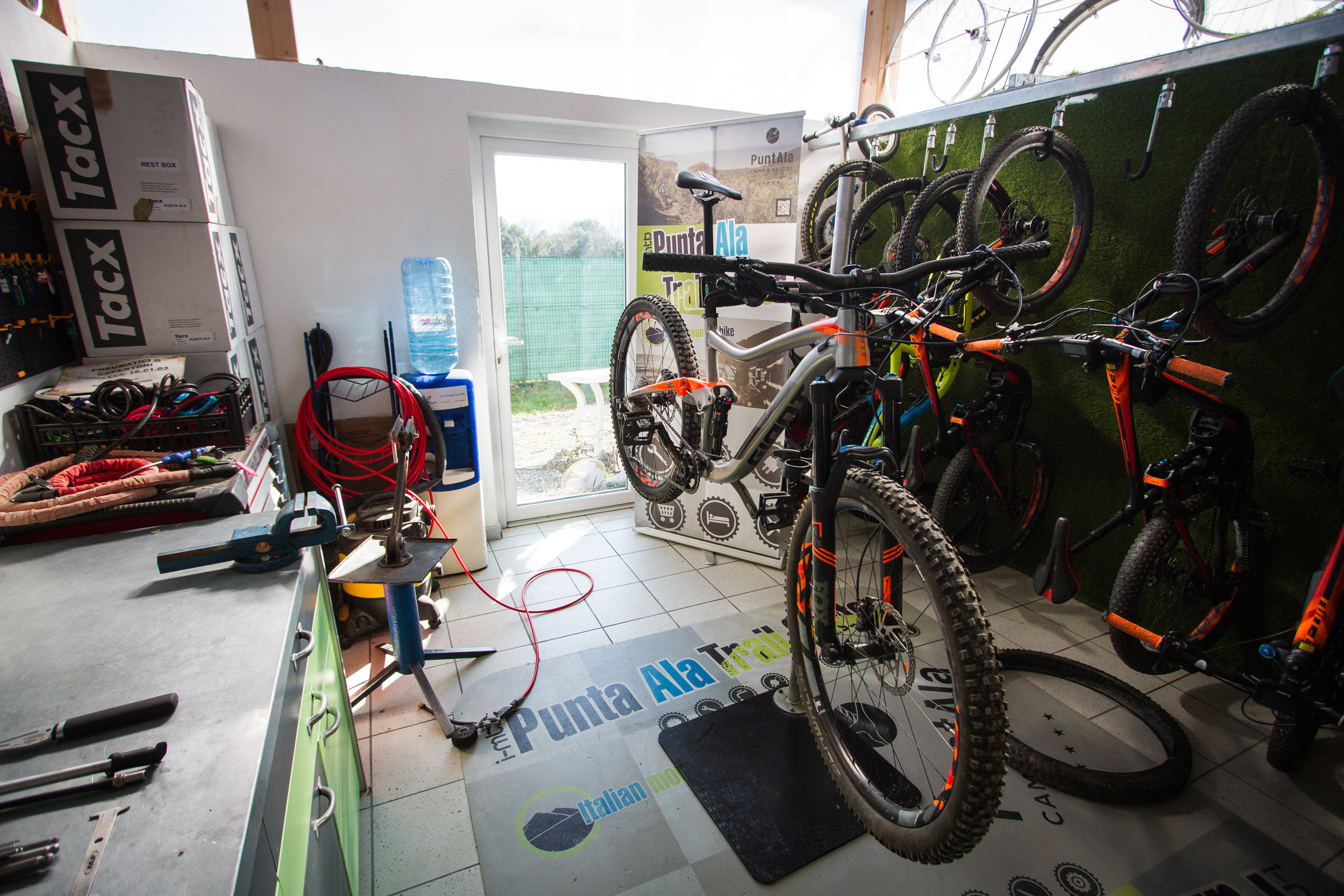 Our Giant Trance Enduro bike in the stand at the Punta Ala Trail Center Repair shop.